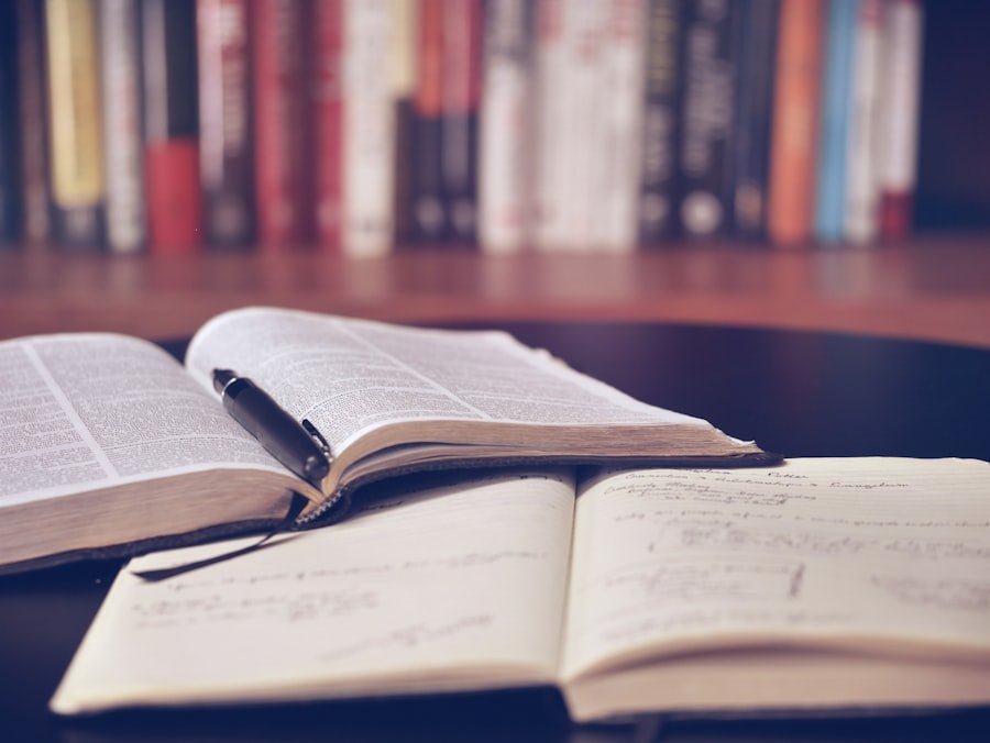Open notebook and stacked books on a study desk
